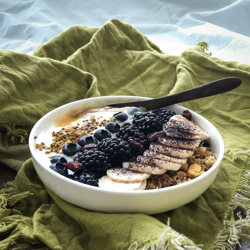 Cereal bowl with fruit, yogurt and bee pollen granules